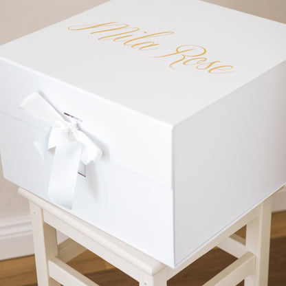 A sturdy, rigid collapsible gift box made from 2.8mm (approx.) board and covered with a bright white paper inside and a protective matte laminate coating inside and out.  Makes any gift a delightful surprise for any recipient.