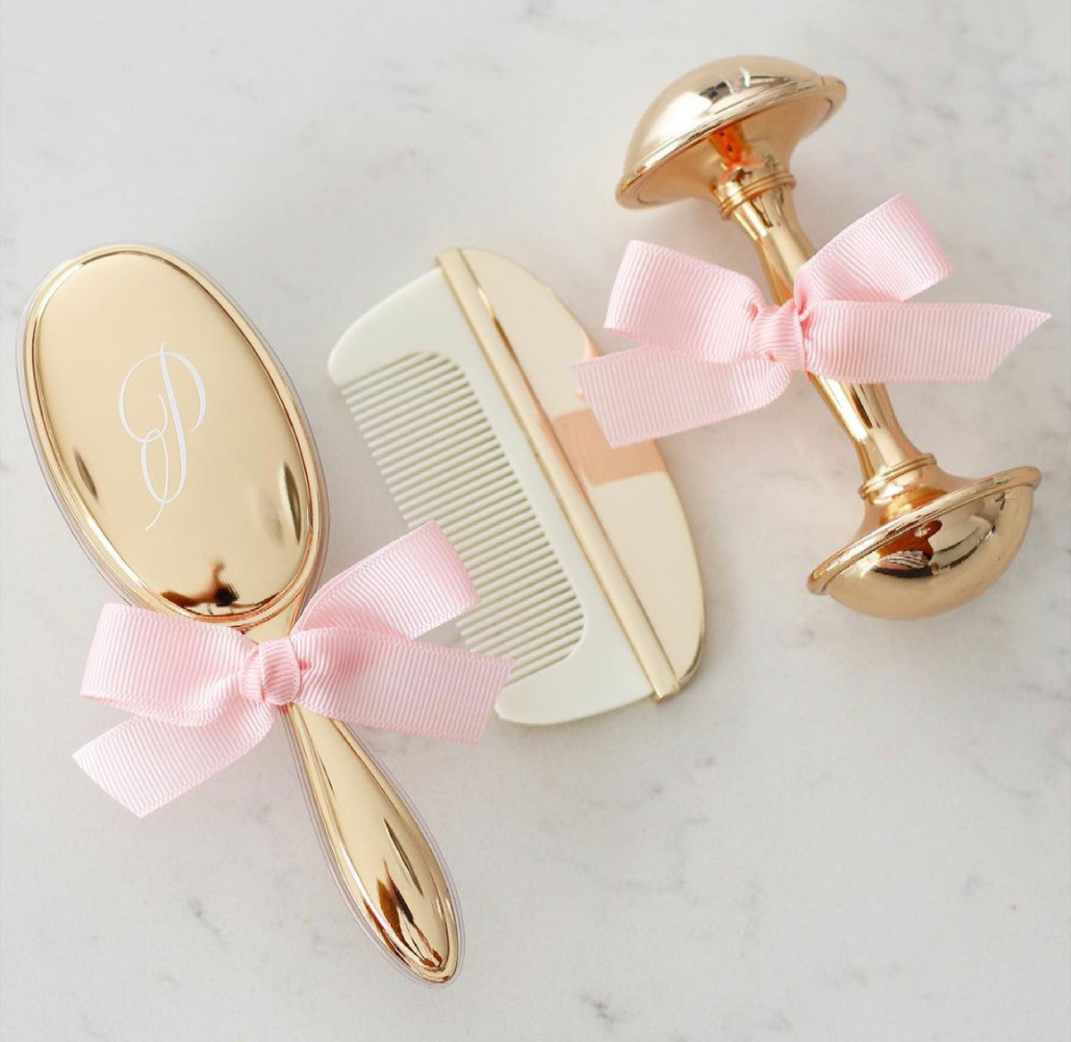 Gold or Silver plated plated brush and comb set & Rattle, which comes in a box. Can be personalised with lettering. 