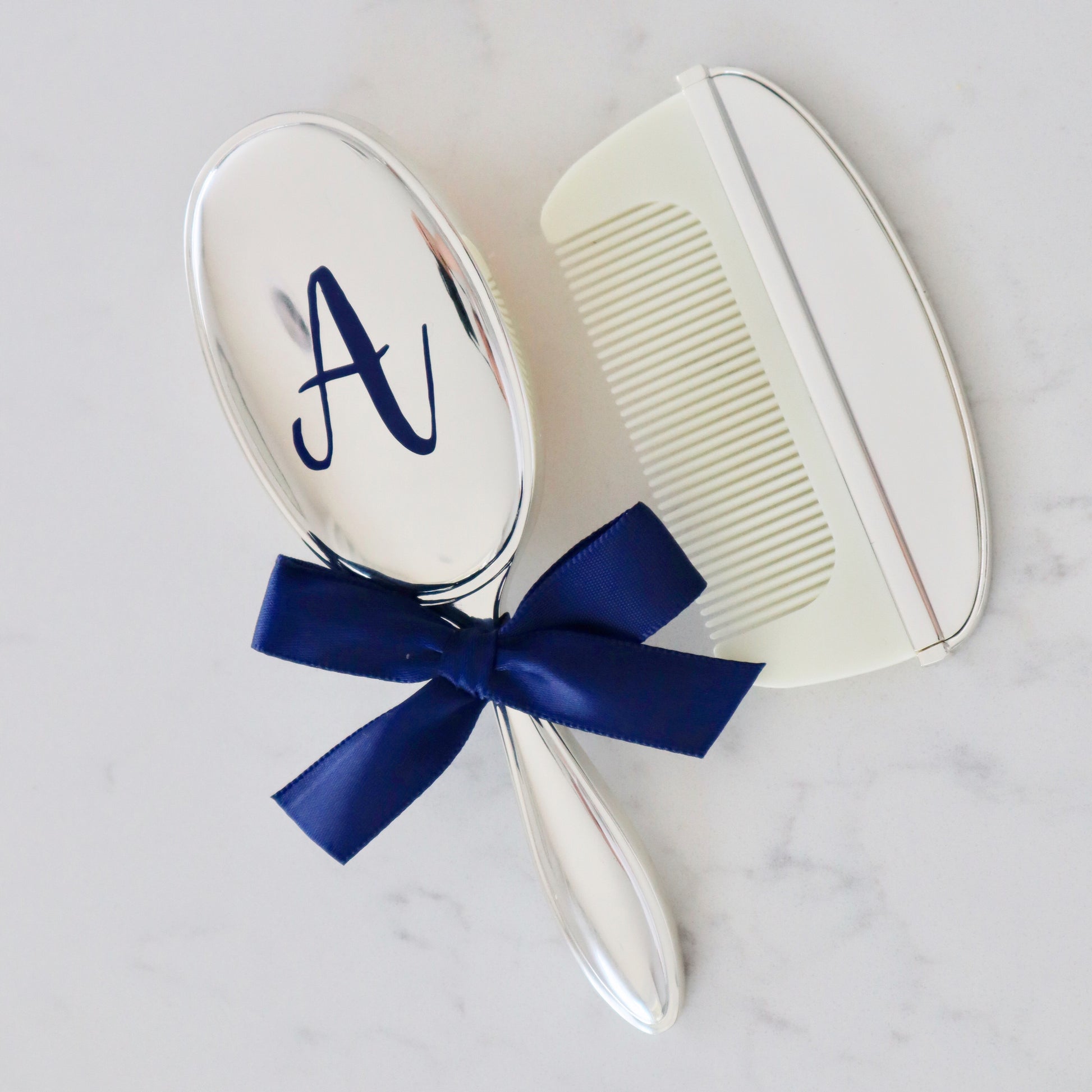 Silver, Gold, or Rose Gold plated baby brush and comb set, which comes in a box. The brush can personalised on the back with 1-2 initials.