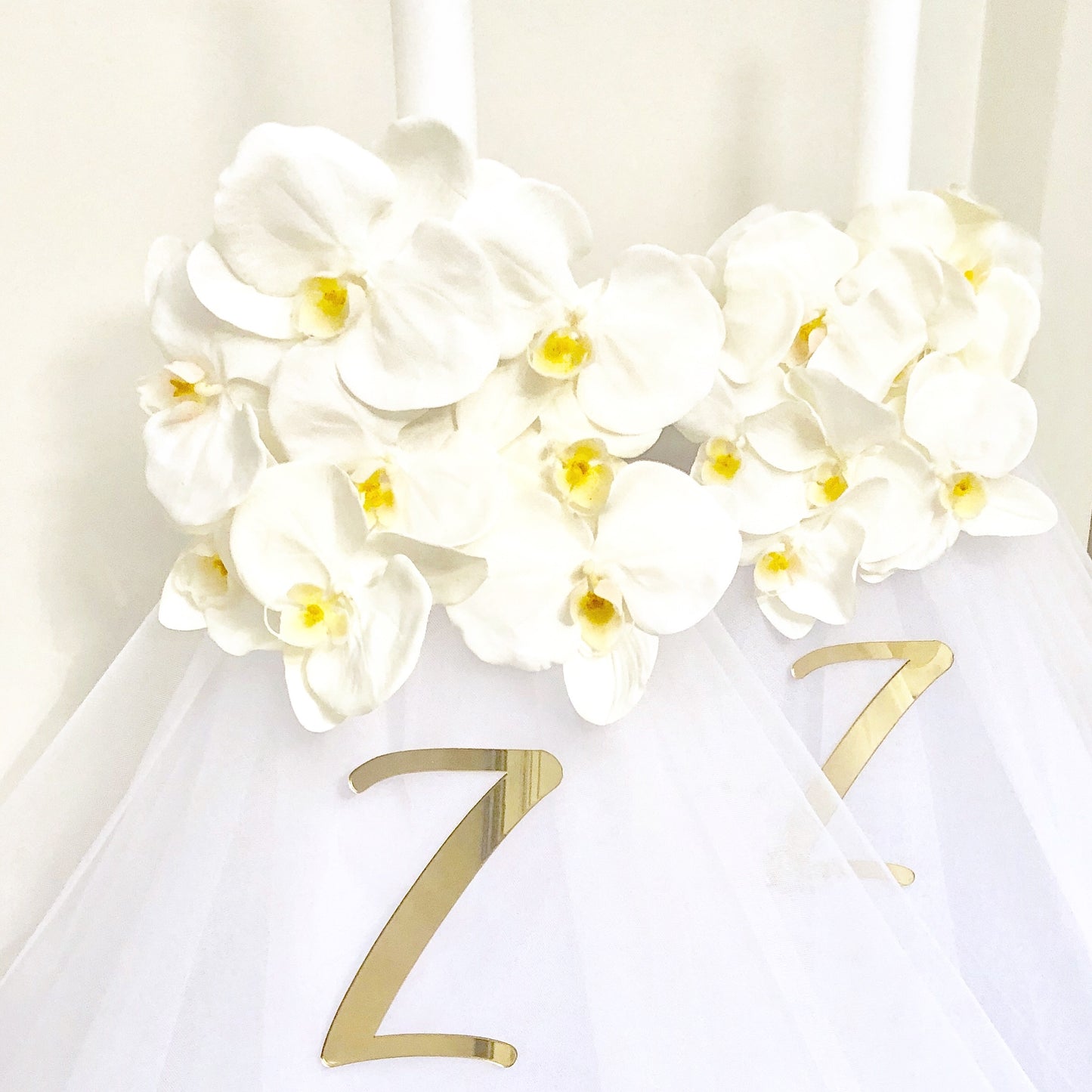 Our collection of exquisite Orthodox White Florals with Orchid candles, are meticulously crafted to add a touch of beauty and spirituality to your religious ceremonies.