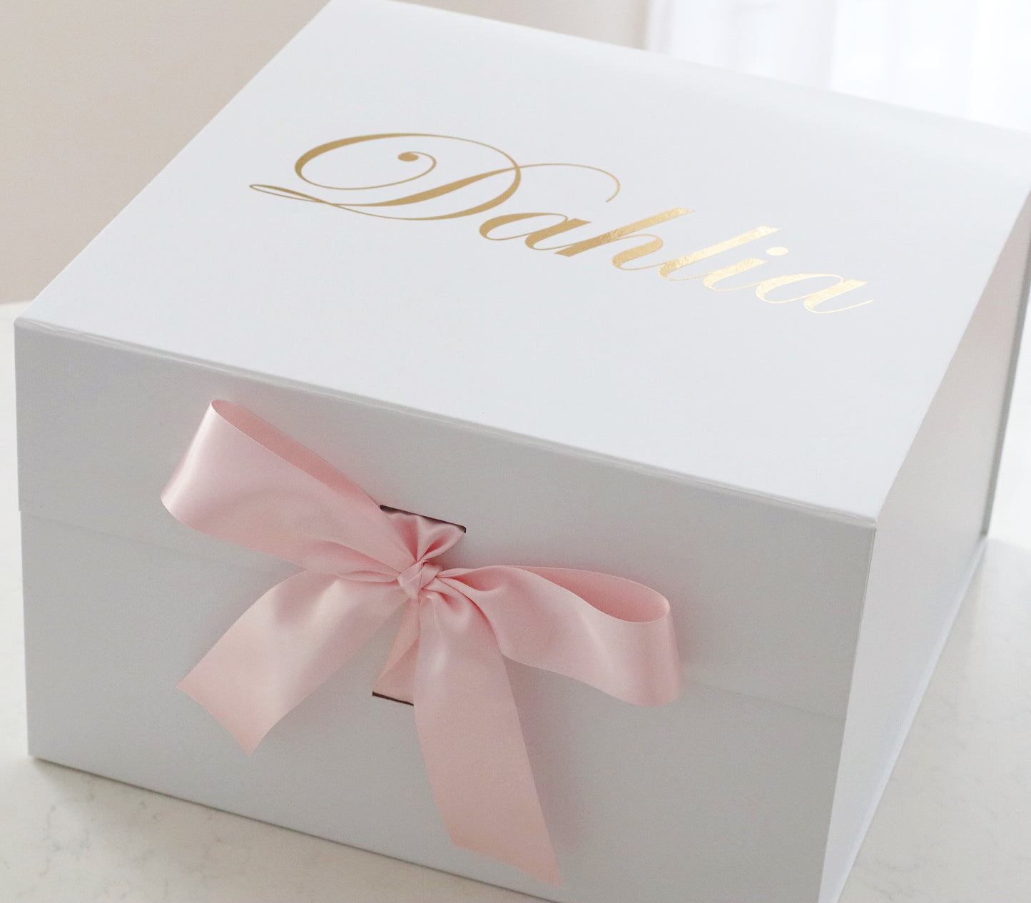 A sturdy, rigid collapsible gift box made from 2.8mm (approx.) board and covered with a bright white paper inside and a protective matte laminate coating inside and out.  Makes any gift a delightful surprise for any recipient.