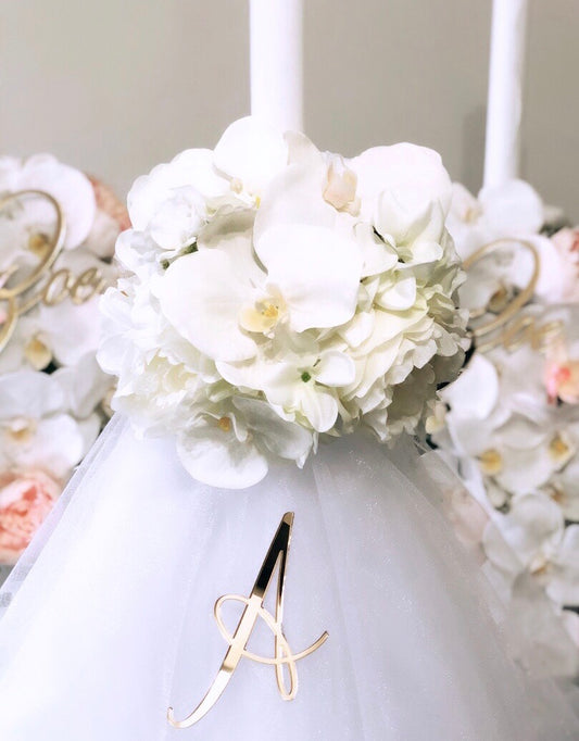 Our collection of exquisite Orthodox White Florals with Orchid candles, are meticulously crafted to add a touch of beauty and spirituality to your religious ceremonies.